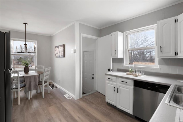 kitchen with crown molding, stainless steel dishwasher, freestanding refrigerator, white cabinetry, and wood finished floors