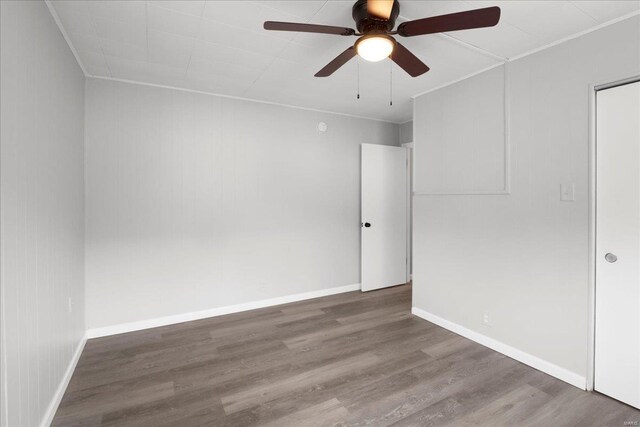 spare room with ceiling fan, baseboards, and wood finished floors