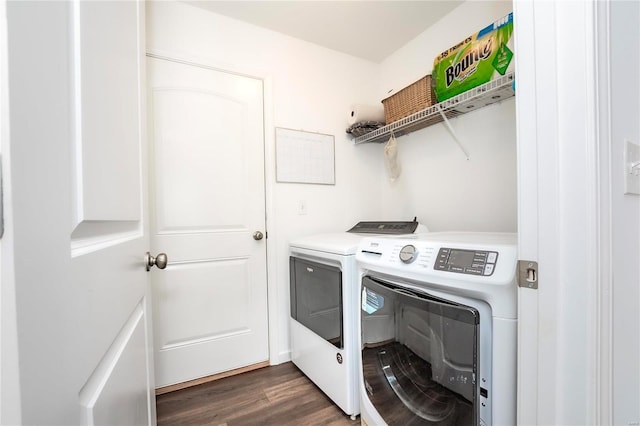 clothes washing area featuring laundry area, separate washer and dryer, and dark wood-type flooring