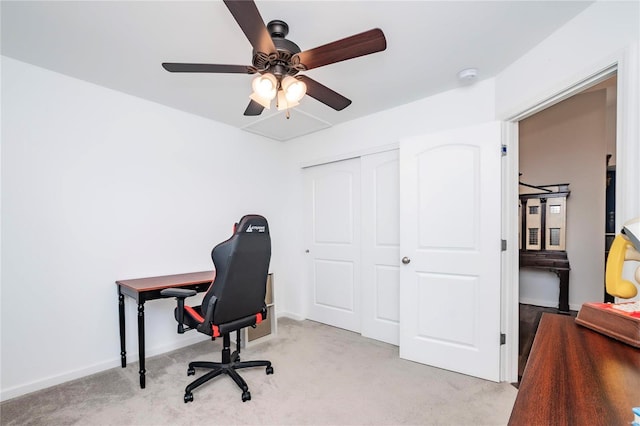 carpeted office featuring ceiling fan and baseboards