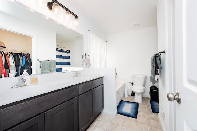 full bath with a walk in closet, visible vents, a sink, and double vanity