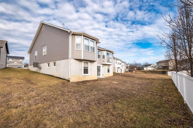 rear view of property with a lawn, fence, and a residential view