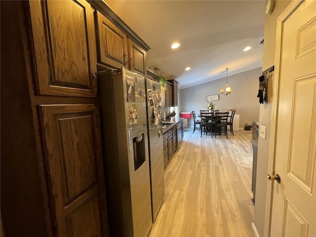 kitchen featuring lofted ceiling, recessed lighting, light wood-type flooring, stainless steel refrigerator with ice dispenser, and decorative light fixtures