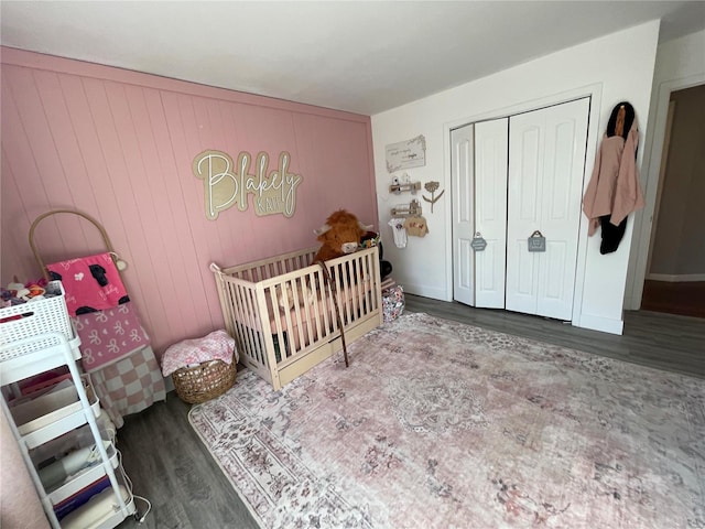 bedroom featuring a closet, wood finished floors, and baseboards