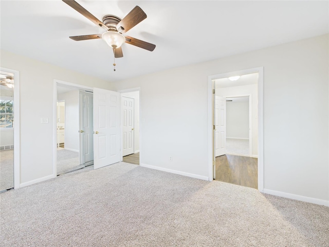 unfurnished bedroom with carpet flooring, a ceiling fan, and baseboards