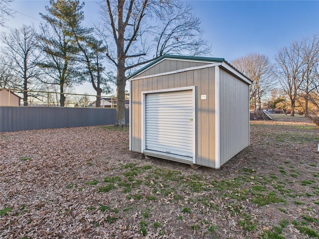 view of shed featuring fence