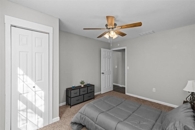 bedroom with ceiling fan, visible vents, baseboards, a closet, and carpet