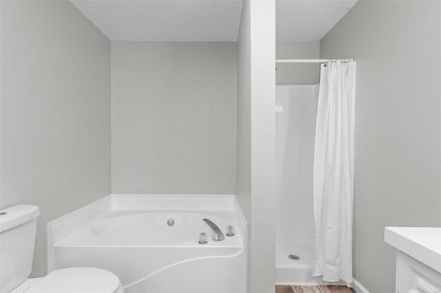 bathroom featuring a bath, a stall shower, vanity, and toilet