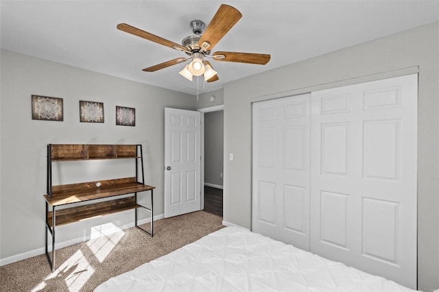 bedroom with a closet, carpet, a ceiling fan, and baseboards