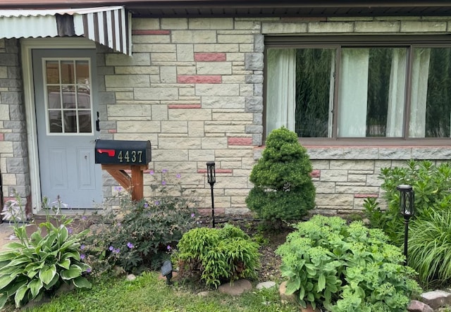 view of side of property with stone siding