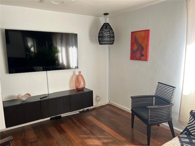 sitting room featuring baseboards and wood finished floors