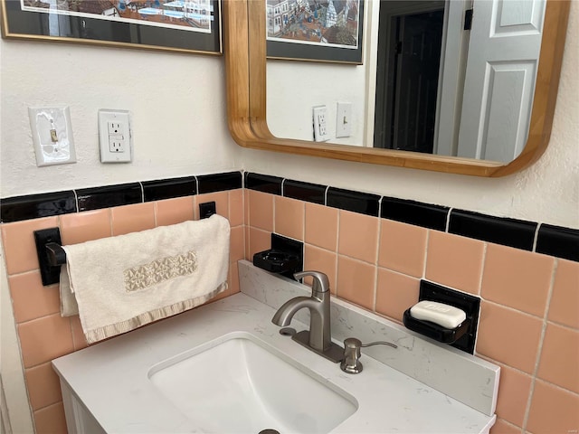 bathroom with a sink and tasteful backsplash