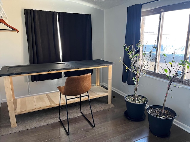 home office featuring a wealth of natural light, dark wood-type flooring, and baseboards