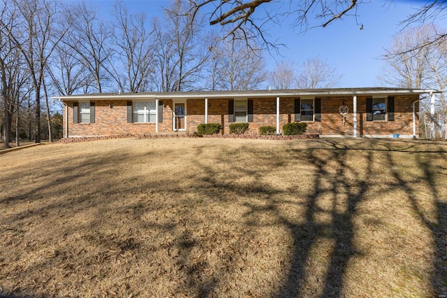 ranch-style house featuring a porch, a front yard, and brick siding