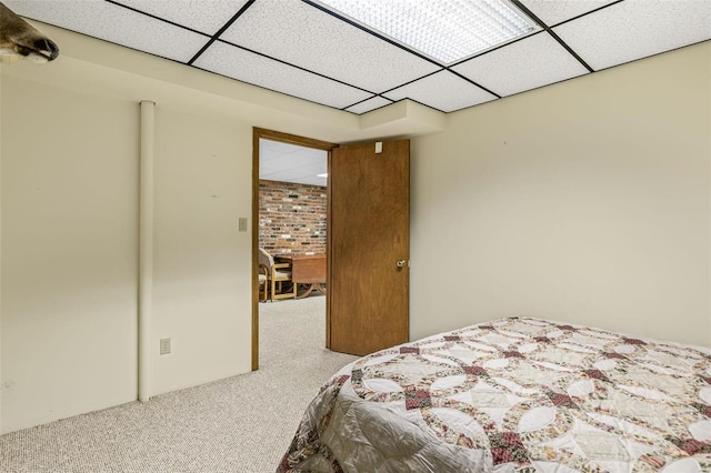 carpeted bedroom with a drop ceiling