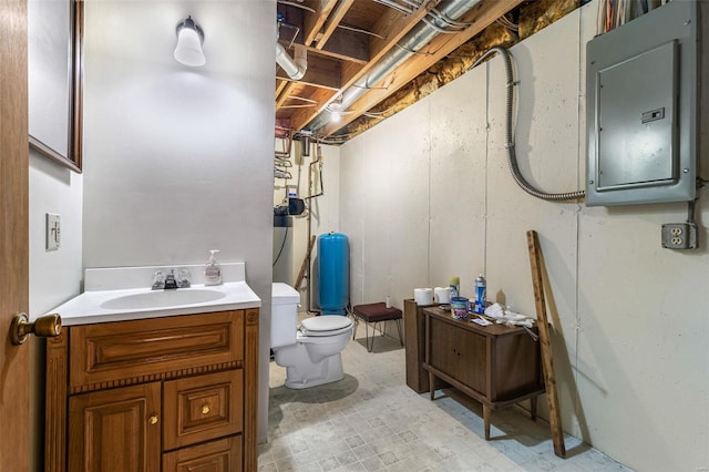 bathroom with electric panel, vanity, and toilet