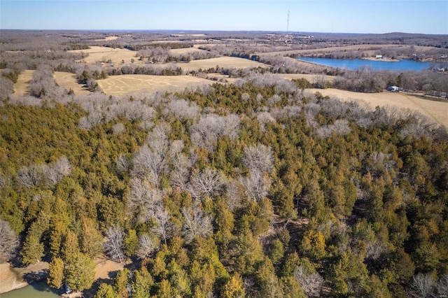 aerial view featuring a water view and a wooded view