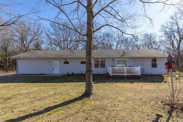 view of front of home featuring a front yard and a deck