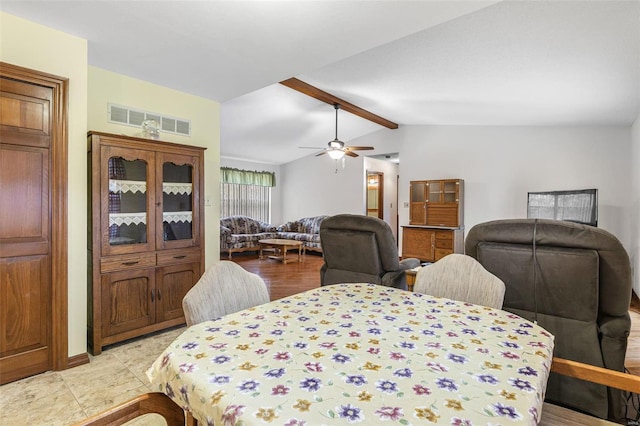 dining area with a ceiling fan, visible vents, and lofted ceiling with beams