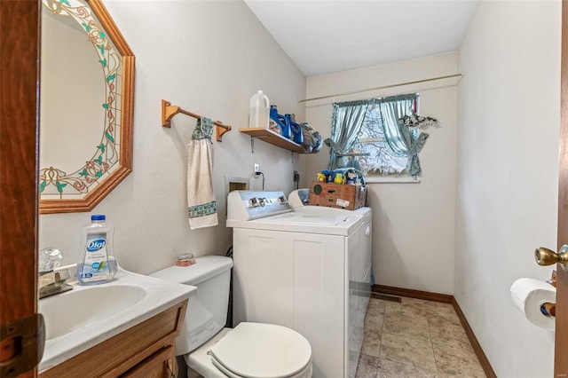 bathroom with baseboards, independent washer and dryer, vanity, and toilet