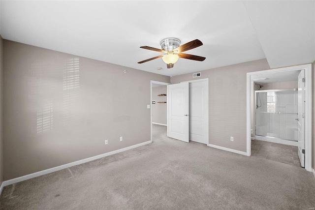 unfurnished bedroom with carpet, visible vents, baseboards, ceiling fan, and connected bathroom