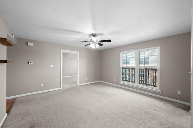 unfurnished room with visible vents, baseboards, light carpet, and a ceiling fan