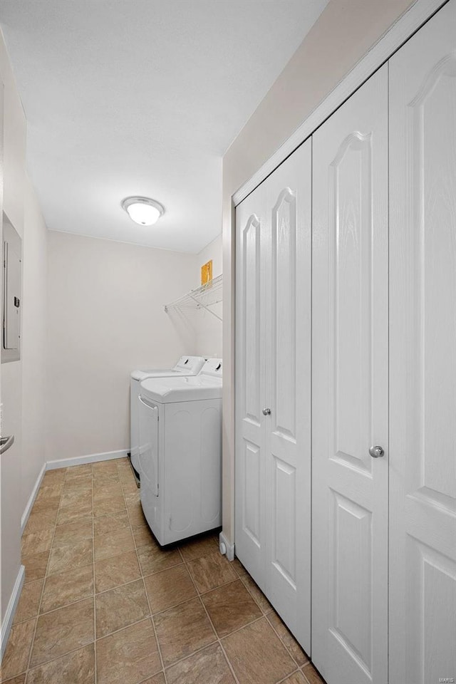 laundry area with electric panel, baseboards, independent washer and dryer, and laundry area