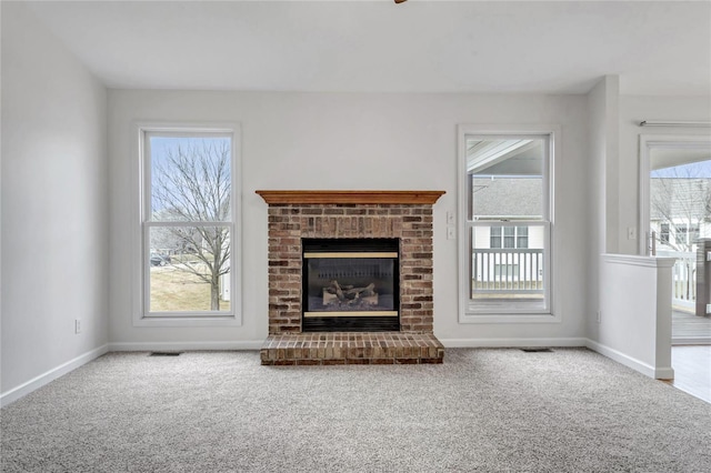 unfurnished living room with plenty of natural light, carpet, and a fireplace