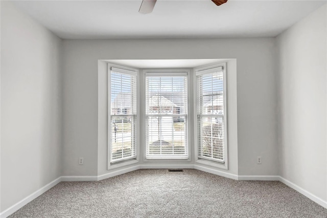 empty room featuring carpet floors and a healthy amount of sunlight