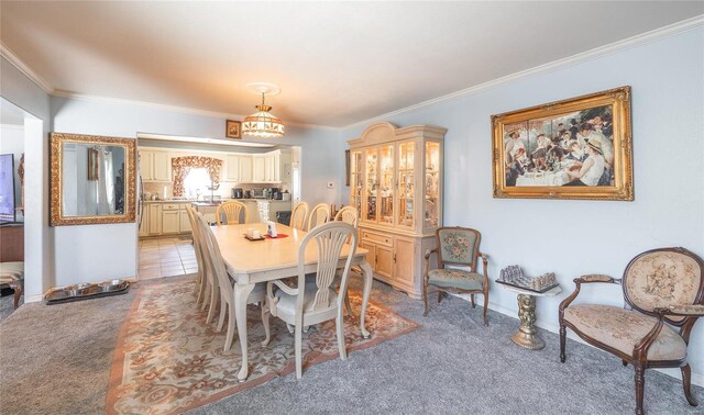 dining room with light colored carpet, light tile patterned flooring, and crown molding