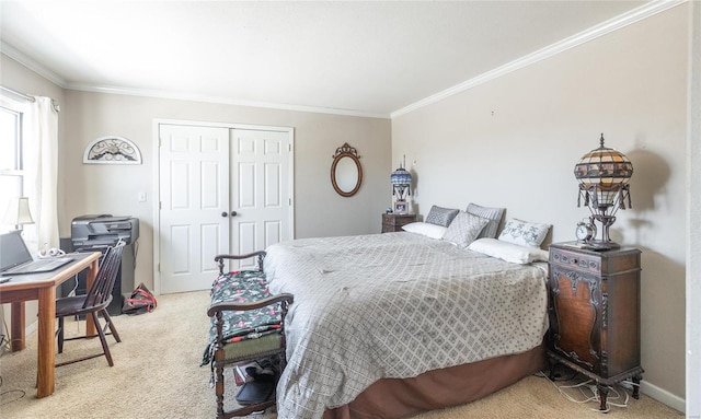 carpeted bedroom with a closet, baseboards, and crown molding