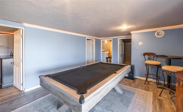 rec room featuring billiards, crown molding, wood finished floors, and a textured ceiling