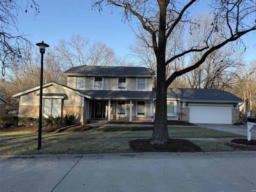 view of front of home featuring covered porch, concrete driveway, and an attached garage