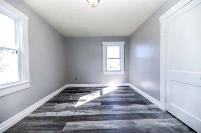 additional living space featuring baseboards and wood finished floors