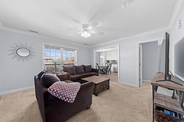 carpeted living room with a ceiling fan, visible vents, crown molding, and baseboards