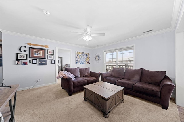 living area featuring light carpet, ceiling fan, visible vents, and ornamental molding