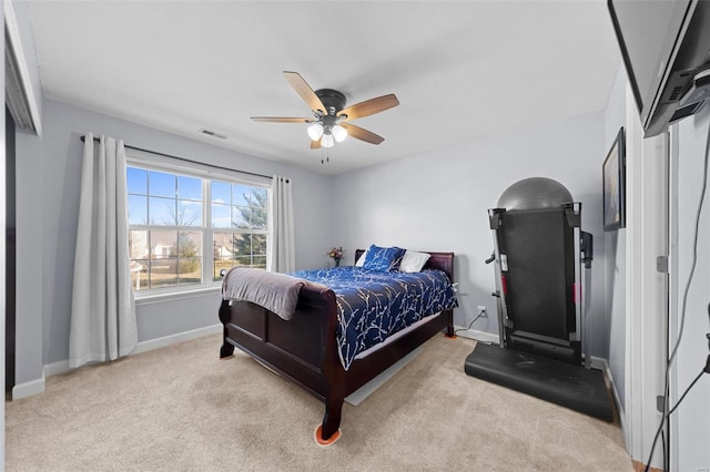 carpeted bedroom featuring ceiling fan, visible vents, and baseboards