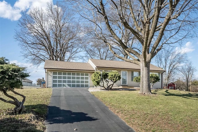 view of front of home featuring a garage, driveway, and a front yard