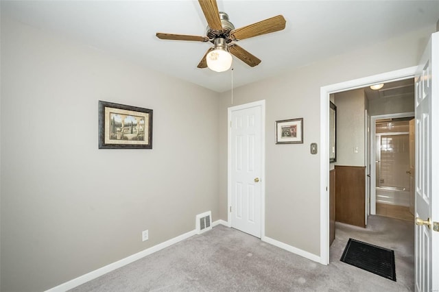 unfurnished bedroom with a ceiling fan, light colored carpet, visible vents, and baseboards