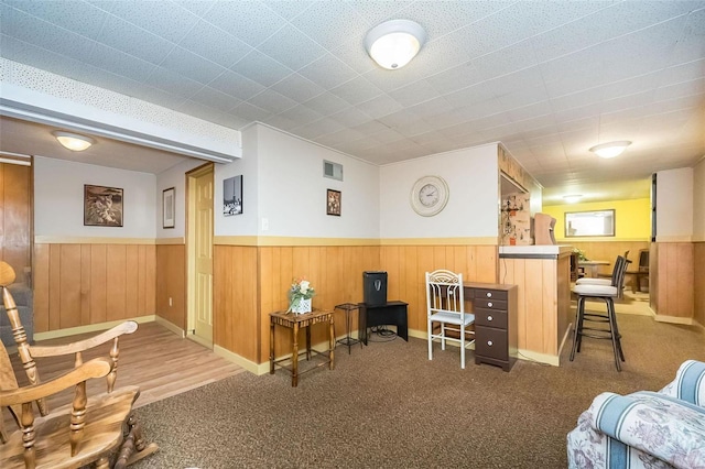 interior space featuring carpet, wainscoting, and visible vents