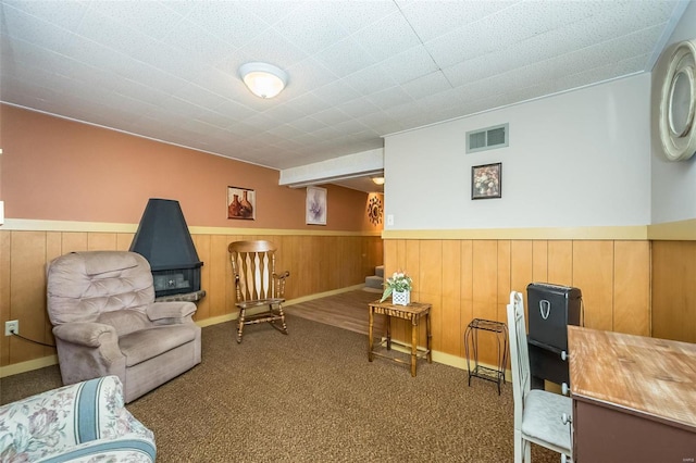 sitting room featuring carpet, a wainscoted wall, and visible vents