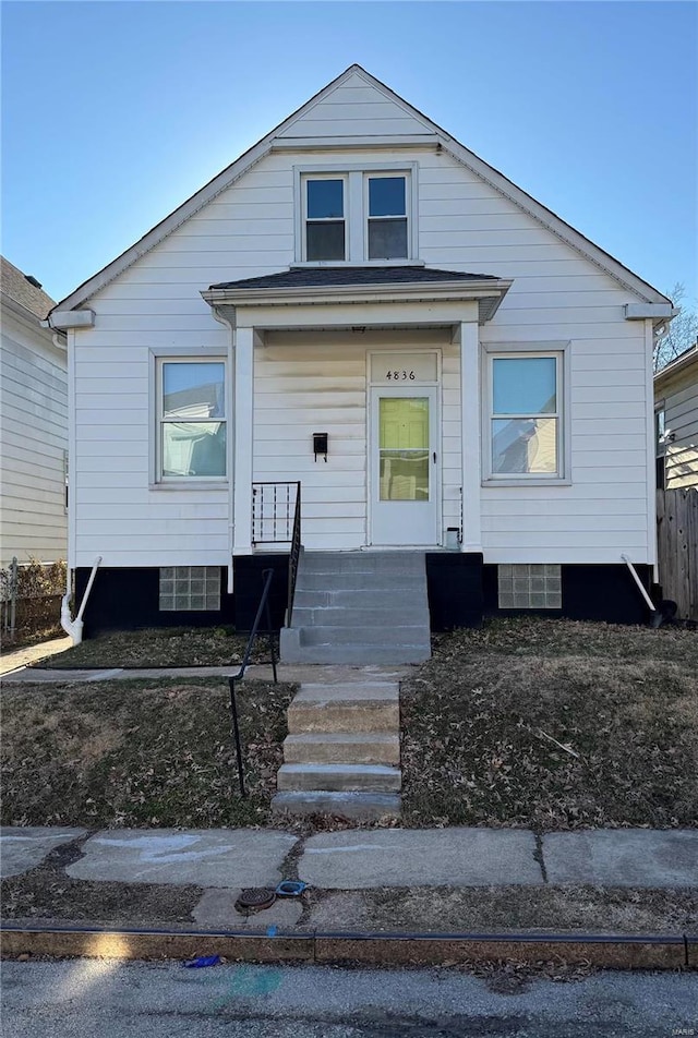 bungalow featuring a porch and fence