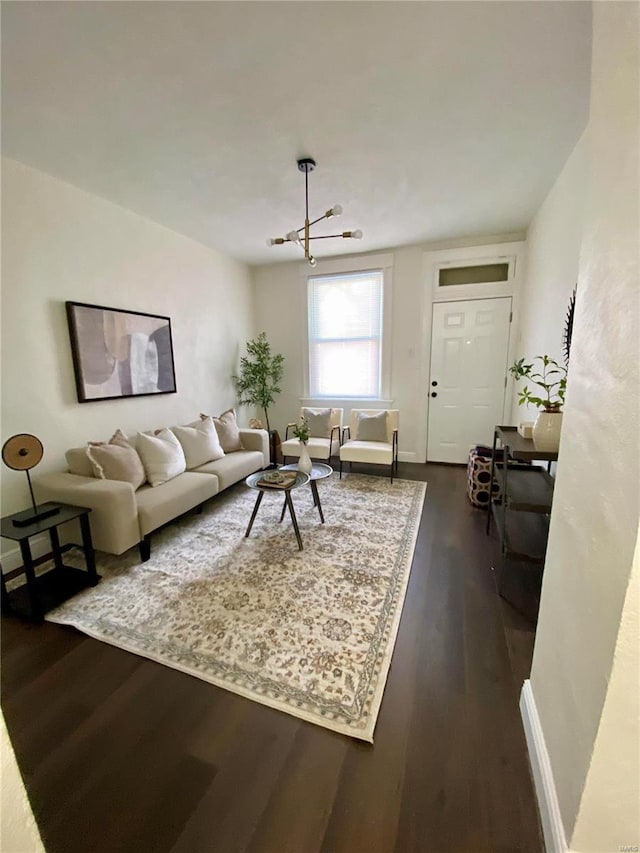 living area featuring baseboards and dark wood-type flooring