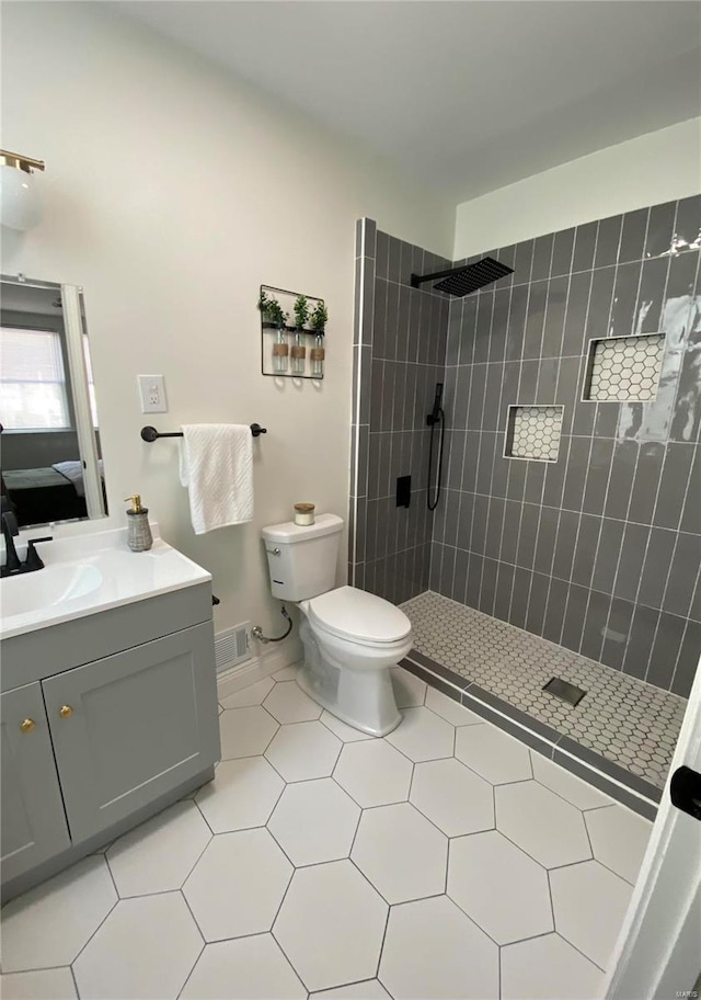 bathroom with toilet, ensuite bath, visible vents, and tiled shower