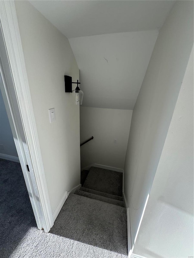 stairs with vaulted ceiling, carpet flooring, and baseboards