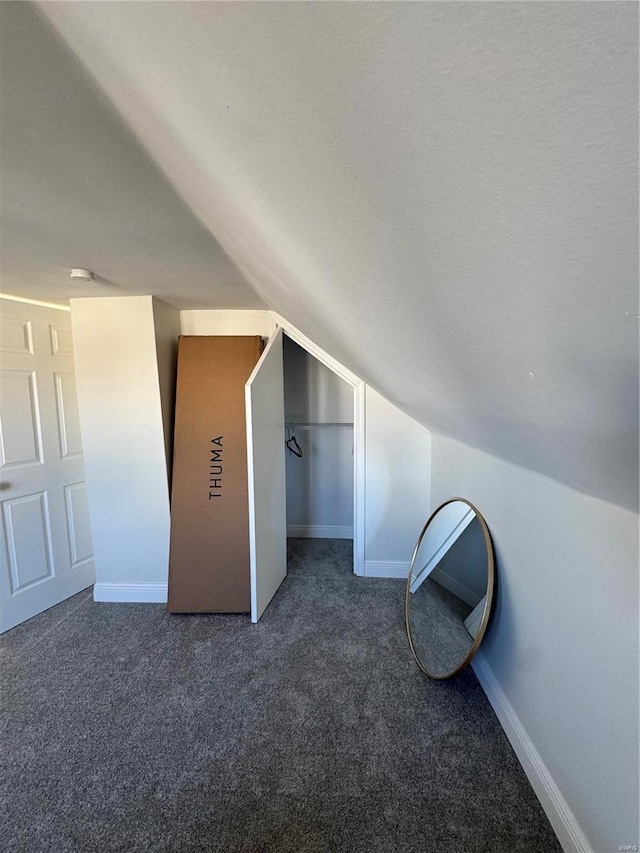 bonus room with carpet floors, baseboards, and lofted ceiling