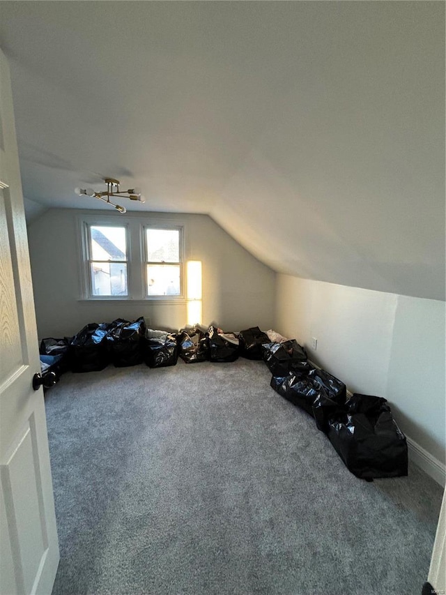 additional living space with lofted ceiling and carpet