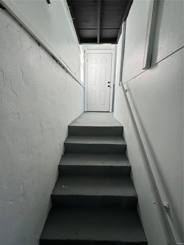 stairway with a textured wall