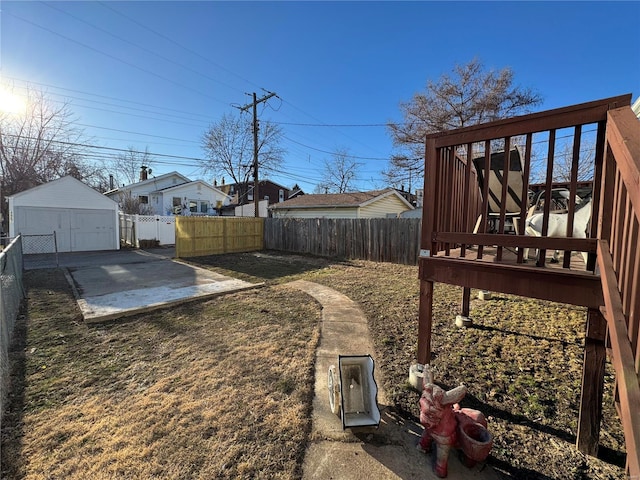 view of yard featuring an outbuilding, a patio area, a fenced backyard, and a garage