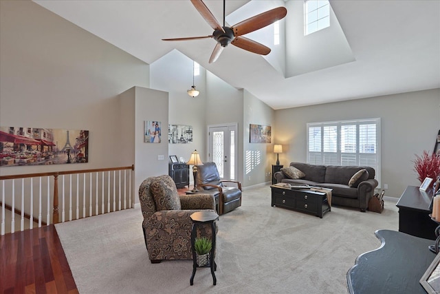 living room with high vaulted ceiling, carpet, baseboards, and a ceiling fan